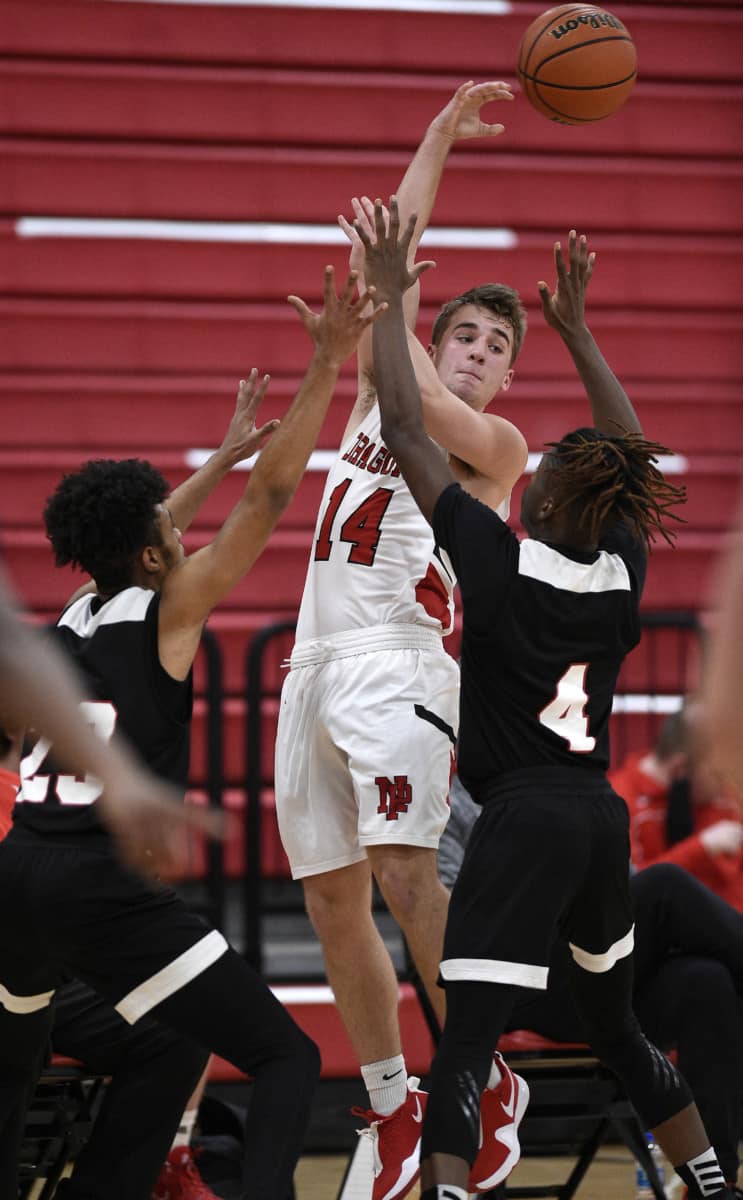 New Palestine's Blaine Nunnally passes the ball against Heron High School Academy on Wednesday, Jan. 27, 2021. (Tom Russo | Daily Reporter)