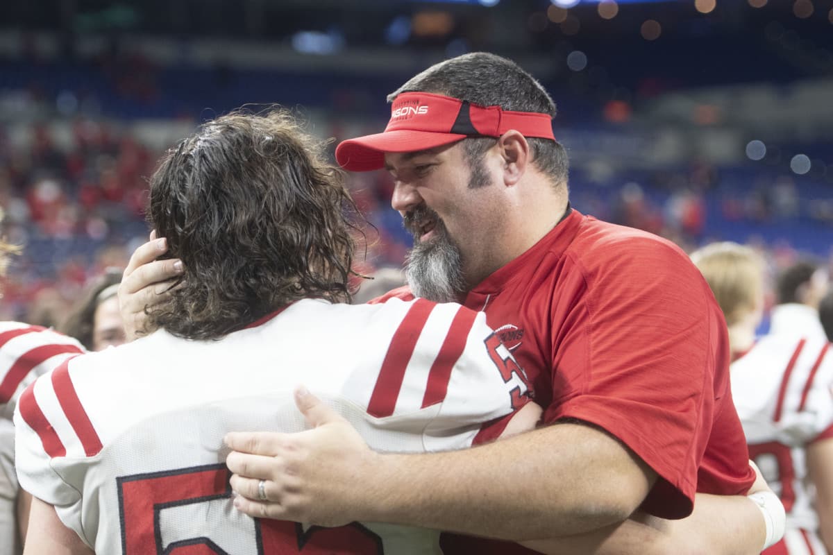 New Palestine head coach Kyle Ralph celebrates with Kyle King moments after winning the IHSAA 5A State Championship after defeating Valparaiso, 27-21, in the state final on Friday, Nov. 29, 2019. (Tom Russo | Daily Reporter)