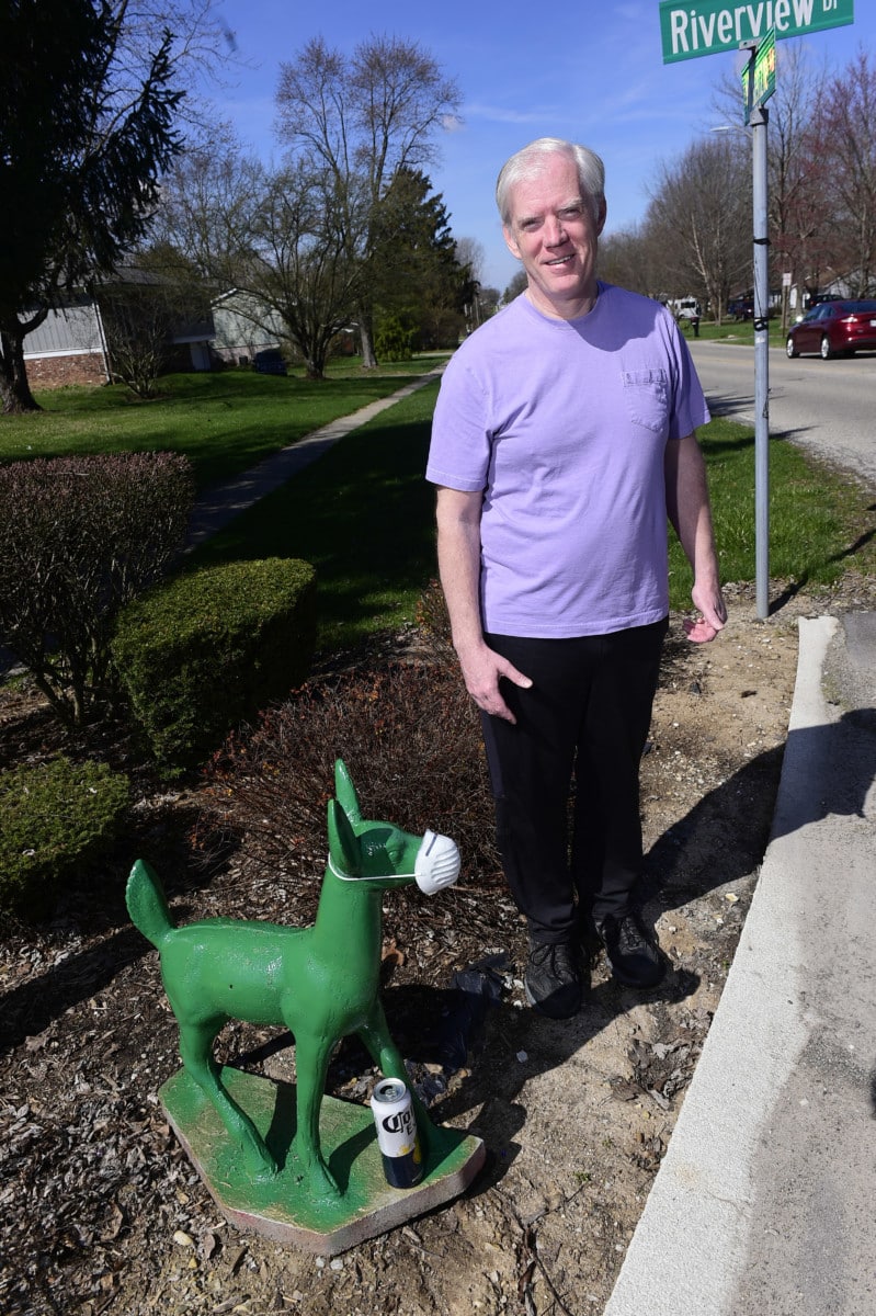 Michael Cooper stands in front of the lawn ornament that now stands at the entrance of Waterview Estates in Greenfield along McKenzie Road. (Tom Russo | Daily Reporter)