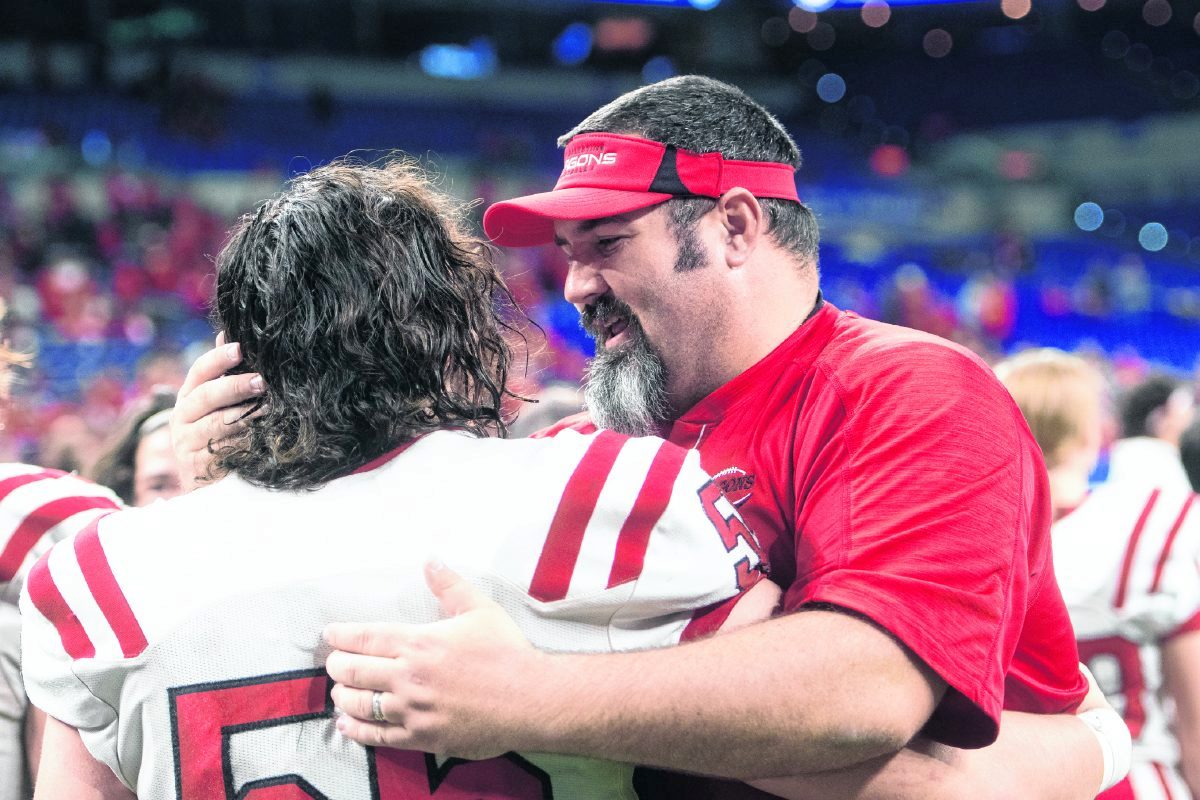 New Palestine head football coach Kyle Ralph celebrates with Kyle King moments after winning the IHSAA Class 5A state championship, defeating Valparaiso, 27-21, in the state finals on Friday, Nov. 29, 2019. (Tom Russo | Daily Reporter)