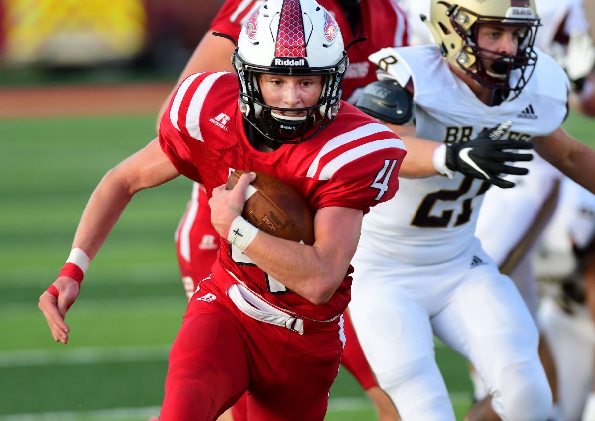 New Palestine’s Grayson Thomas runs to the end zone for a touchdown against Brebeuf Jesuit on Friday, Aug. 28, 2020. (Tom Russo | Daily Reporter)
