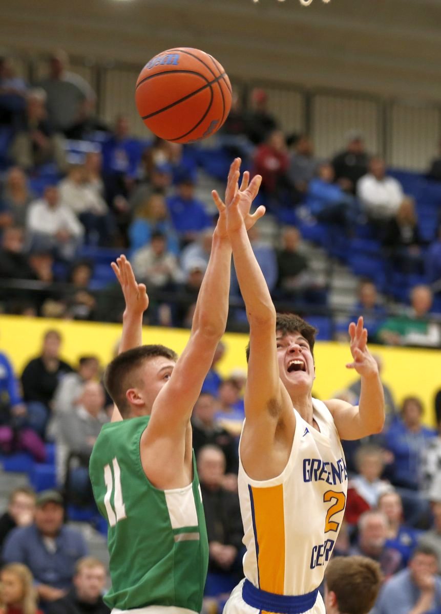 Greenfield-Central’s Gavin Robertson (2) battles for the ball against New Castle’s William Grieser (11) during their game on Jan. 17, 2020. (Rob Baker/Daily Reporter)