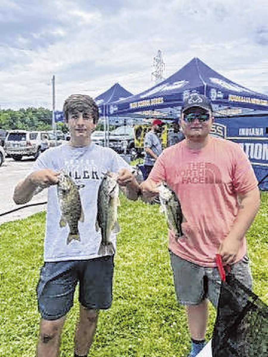 Jack Johnson and Kobe Calvert, members of the New Palestine High School fishing team, display the bass they caught to take 11th place in the Indiana BASS Nation High School State Championship contest on June 6 at Brookville Lake.  Submitted