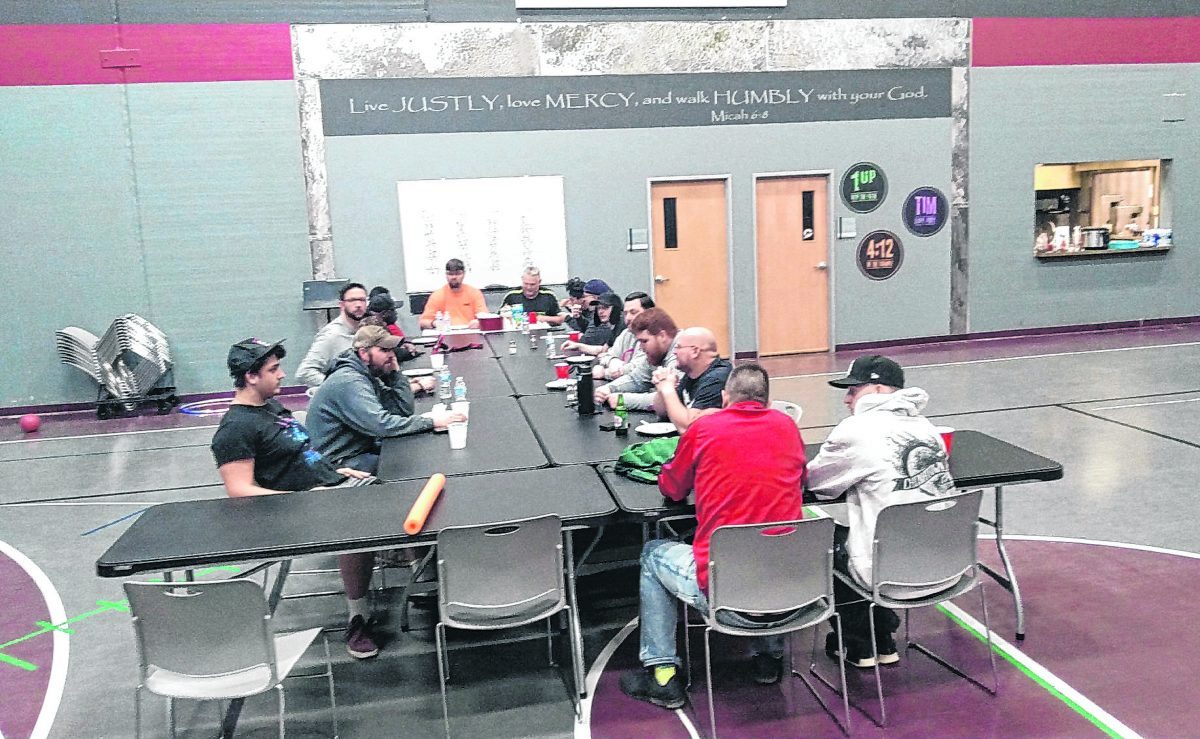 The Community of Men group gathers over a meal in the gym at Brandywine Community Church. Men's groups of the church are working together on a May 22 car show there.  Photo provided