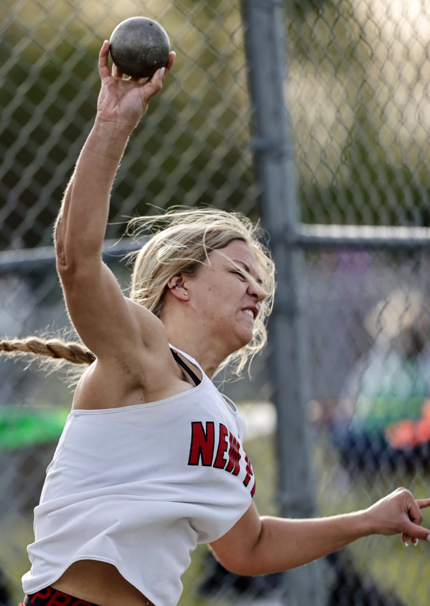 New Palestine’s Faith Hensel releases the shot put on her way to a second-place finish at the 2021 Hoosier Heritage Conference girls track and field championships at Mt. Vernon High School on Tuesday, May 11, 2021. (Rob Baker/Daily Reporter) 