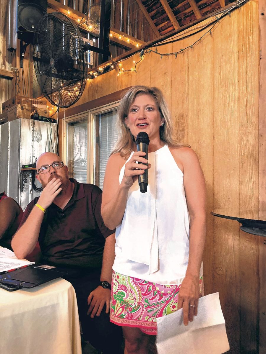 Morgan Acres owner Shani Williams speaks at a town hall meeting at her property about development issues, while event moderator John Streeter watches. (Jessica Karins | Daily Reporter)