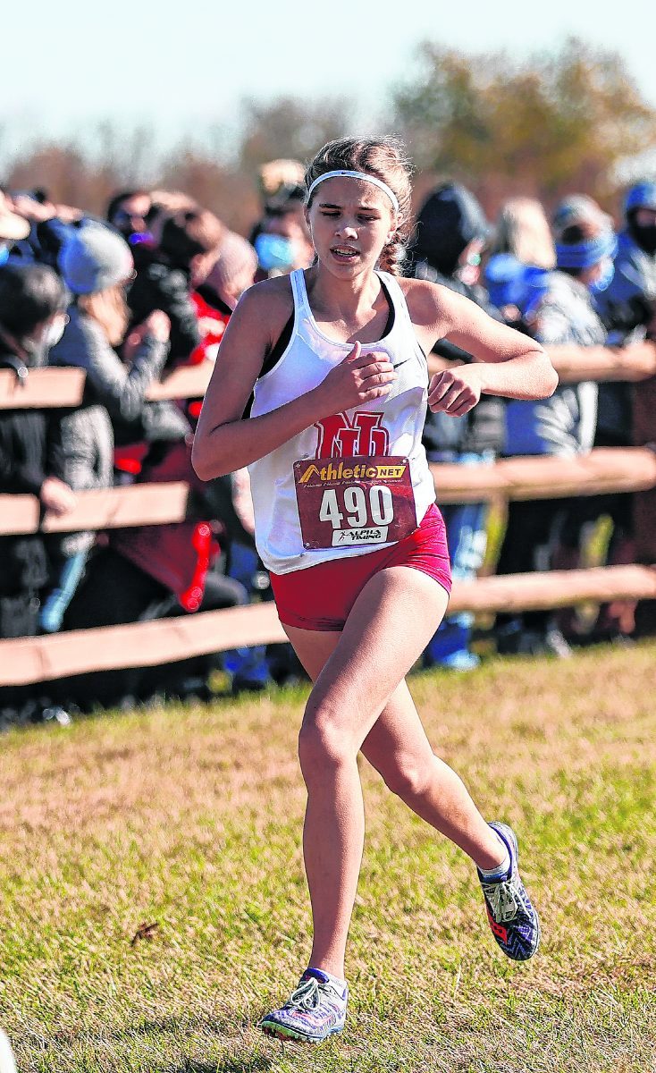 New Palestine's Emma Mann (490) crosses the finish line in 26th place with a time of 19:16.3 at the Shelbyville Semistate Cross-Country Meet at Blue River Memorial Park. (Rob Baker/Daily Reporter file)