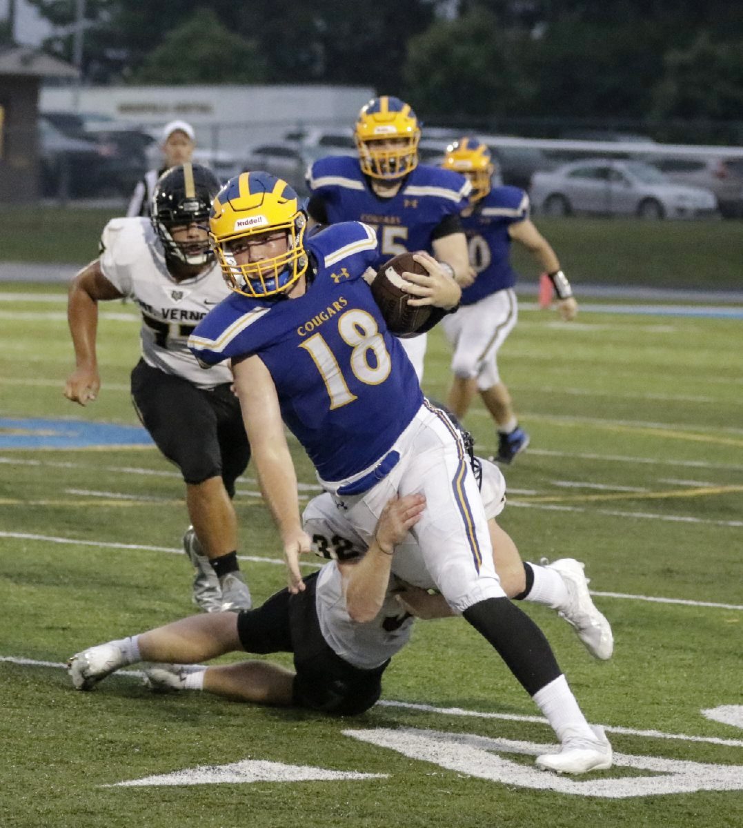 Mt. Vernon's Keagan La Belle (32) makes a sliding tackle on Greenfield-Central's Brodie Mayberry (18) before he can get around the corner on Saturday, Sept. 4, 2021. (Rob Baker/Daily Reporter)