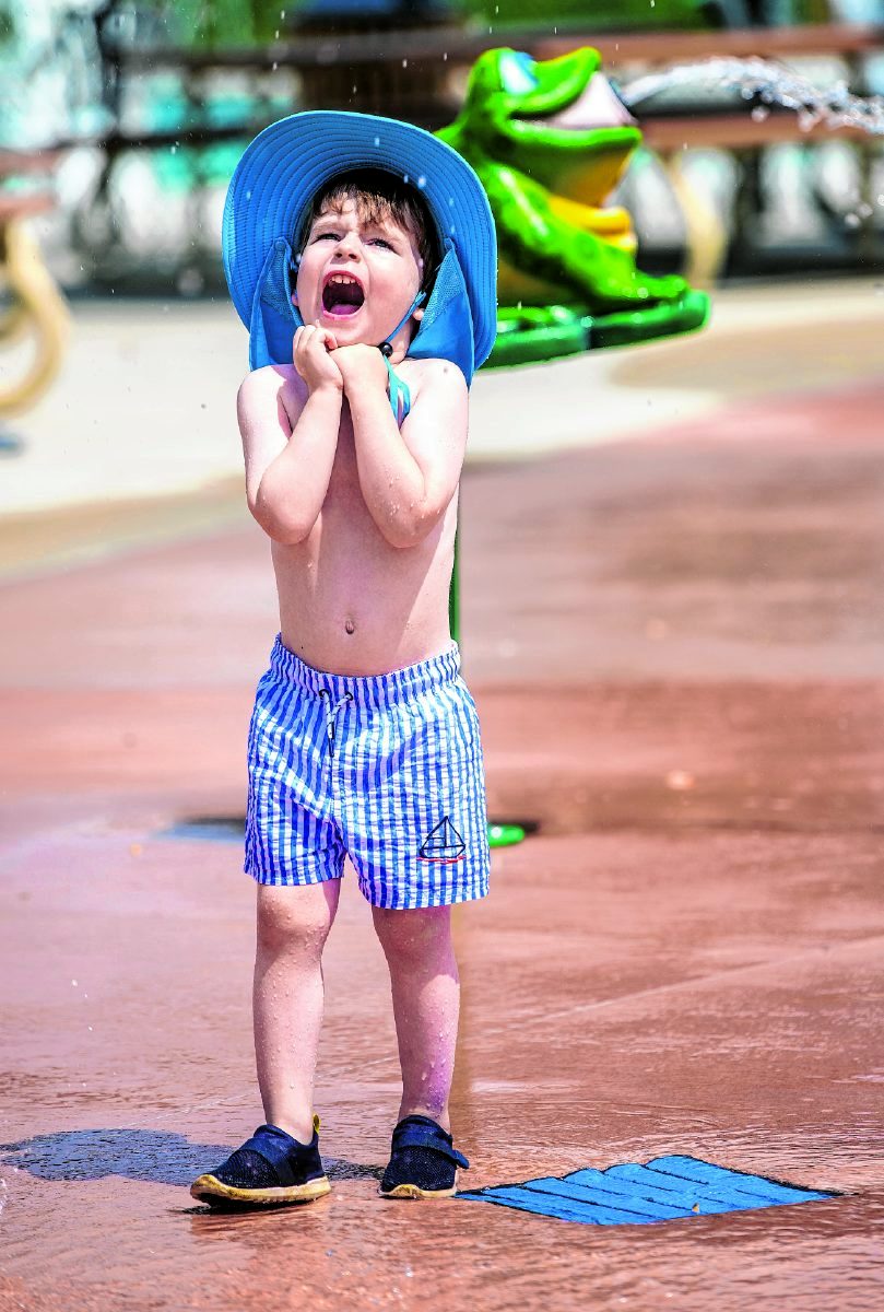 Rhys Taylor catches some drops during a visit to the splash pad. (Tom Russo | Daily Reporter)