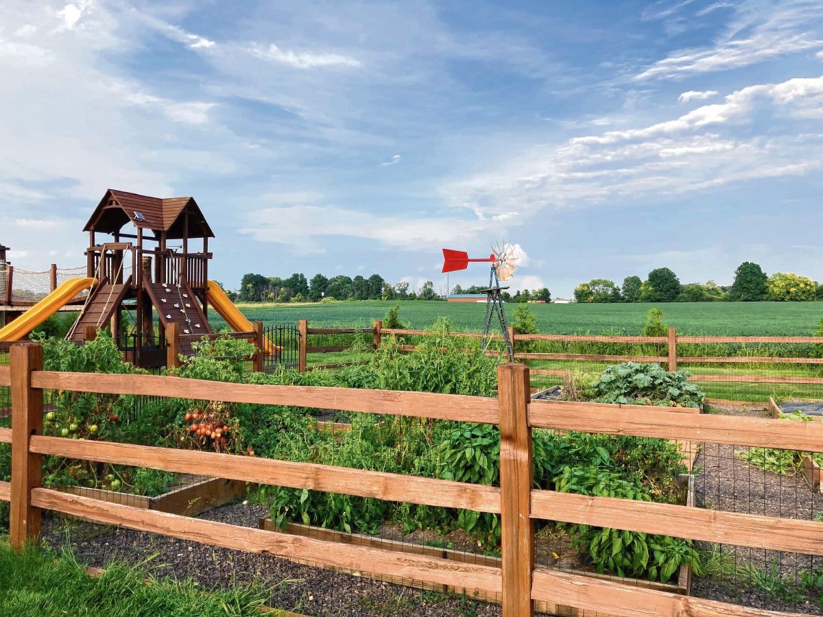 On one side of the Marion-Hancock County line is Morgan Acres' playground and community garden. On the other, the soybean field next door is the proposed site of an industrial development. (Jessica Karins | Daily Reporter)