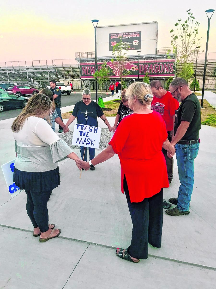 The parent protest opened and closed in a group prayer. (Kristy Deer | Daily Reporter)